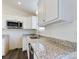 Modern kitchen with white cabinets, granite countertops, and stainless steel appliances at 2061 Gary Ln, Hickory, NC 28602
