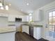 Modern kitchen with island, white cabinets, granite countertops, and stainless steel appliances at 2061 Gary Ln, Hickory, NC 28602