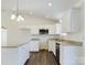 Modern kitchen with island, granite countertops, and white cabinets at 2061 Gary Ln, Hickory, NC 28602