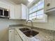 Modern kitchen with white cabinets, granite countertops, and a double sink at 2061 Gary Ln, Hickory, NC 28602