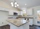 Modern kitchen with island, white cabinets, granite countertops, and stainless steel appliances at 2061 Gary Ln, Hickory, NC 28602