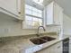 Modern kitchen with white cabinets, granite countertops, and a double sink at 2061 Gary Ln, Hickory, NC 28602
