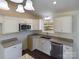 Modern kitchen with white cabinets, granite countertops, and stainless steel appliances at 2061 Gary Ln, Hickory, NC 28602