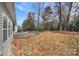 A backyard featuring a stone patio and mature trees in a fenced yard at 2481 Bergamot St, Tega Cay, SC 29708