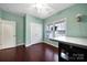 This bedroom is painted in light-green, with hardwood flooring and a bright window at 2481 Bergamot St, Tega Cay, SC 29708