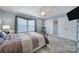 Comfortable bedroom with carpet, ceiling fan, and natural light from the large window at 2481 Bergamot St, Tega Cay, SC 29708