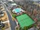 Aerial view of community pool, tennis courts, and clubhouse with well-maintained landscaping at 2481 Bergamot St, Tega Cay, SC 29708