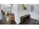 Well-lit hallway featuring hardwood floors, decorative trim, and a glimpse of the inviting living area at 2481 Bergamot St, Tega Cay, SC 29708