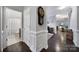 Elegant hallway with wood floors, detailed trim, and access to a bathroom and living area at 2481 Bergamot St, Tega Cay, SC 29708