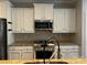 Modern kitchen features stainless steel appliances, granite countertops, and white cabinets for a sleek design at 2481 Bergamot St, Tega Cay, SC 29708