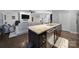 Open-concept kitchen island with granite countertop and stainless steel dishwasher, seamlessly connected to the living area at 2481 Bergamot St, Tega Cay, SC 29708