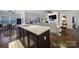 Modern kitchen island featuring a granite countertop and dark wood cabinetry, perfect for food preparation and casual dining at 2481 Bergamot St, Tega Cay, SC 29708
