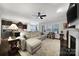 Inviting living room with a large fireplace, seamlessly connects to the modern kitchen with stainless steel appliances at 2481 Bergamot St, Tega Cay, SC 29708