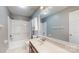 Bathroom with a shower-tub combo and single sink vanity offering storage and functionality at 2605 Willowdale Ln, Matthews, NC 28105