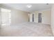 Large bedroom with neutral walls and carpets, showing doors to bath and closet at 2605 Willowdale Ln, Matthews, NC 28105