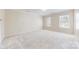 Spacious bedroom with plush carpeting, neutral walls, and abundant natural light from dual windows at 2605 Willowdale Ln, Matthews, NC 28105