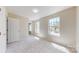 Sun-drenched bedroom with neutral paint, carpet, and large windows offering neighborhood views at 2605 Willowdale Ln, Matthews, NC 28105