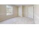 Bright bedroom featuring neutral carpet, trim, paint, and a large window with outdoor views at 2605 Willowdale Ln, Matthews, NC 28105