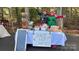 Outdoor Jolly Elf Cookie Stand offering a selection of holiday cookies and treats for sale at 2605 Willowdale Ln, Matthews, NC 28105