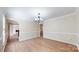 Open dining room featuring hardwood flooring and modern chandelier at 2605 Willowdale Ln, Matthews, NC 28105