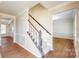 Open-concept entryway with hardwood flooring, stairway, and views of other rooms at 2605 Willowdale Ln, Matthews, NC 28105