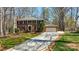 Traditional two-story brick home with a paved driveway and attached garage, showcasing a well-manicured lawn at 2605 Willowdale Ln, Matthews, NC 28105