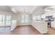 Eat-in kitchen view showcasing stainless appliances, modern finishes, white cabinetry, and wood floors at 2605 Willowdale Ln, Matthews, NC 28105