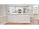 Close-up of the eat-in kitchen featuring white cabinets, stainless appliances, and solid countertops at 2605 Willowdale Ln, Matthews, NC 28105