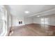 Expansive living room featuring a fireplace, wood floors, and sliding glass doors offering outdoor access at 2605 Willowdale Ln, Matthews, NC 28105