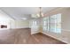 Living room featuring wood floors, a fireplace, large windows, and pool view at 2605 Willowdale Ln, Matthews, NC 28105