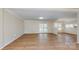 Open-concept living area featuring hardwood floors, French doors, and a view into the adjacent kitchen area at 2605 Willowdale Ln, Matthews, NC 28105