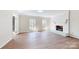 Bright living room with hardwood floors and a white brick fireplace, creating a cozy and inviting atmosphere at 2605 Willowdale Ln, Matthews, NC 28105