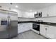 Modern kitchen with stainless steel appliances, white cabinetry, and granite countertops at 404 Morton St, Shelby, NC 28152