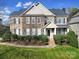 Charming two-story brick home with manicured lawn and stone accents at 8908 Red Barone Pl, Waxhaw, NC 28173