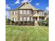 Charming two-story brick home with manicured lawn and stone accents at 8908 Red Barone Pl, Waxhaw, NC 28173