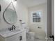Modern bathroom with marble vanity and round mirror at 1402 Springdale Park Dr, Lincolnton, NC 28092