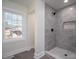 Bathroom with a walk-in shower, grey tile, and a window at 1402 Springdale Park Dr, Lincolnton, NC 28092
