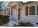 Updated ranch home exterior with white brick, wood shutters, and a covered porch at 1402 Springdale Park Dr, Lincolnton, NC 28092