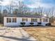 White brick ranch home with brown shutters, landscaping, and a large driveway at 1402 Springdale Park Dr, Lincolnton, NC 28092