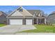 Beautiful brick home featuring a three-car garage and well-manicured lawn at 1603 Croydon St, Indian Land, SC 29707