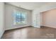 Bright office space with hardwood flooring, a large window, and a glass paneled door at 1603 Croydon St, Indian Land, SC 29707