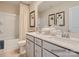 Double vanity bathroom with gray cabinets, white countertops, and shower/tub combo at 1808 Otter Perch Ln, Fort Mill, SC 29715