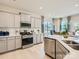 Modern kitchen with gray cabinets, white countertops, and stainless steel appliances at 1808 Otter Perch Ln, Fort Mill, SC 29715