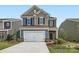 Two-story home with a two-car garage and landscaped lawn at 1812 Otter Perch Ln, Fort Mill, SC 29715