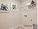 Bright laundry room with shelving and adorable dog art at 1812 Otter Perch Ln, Fort Mill, SC 29715