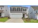 Two-story house with gray and beige exterior, white garage door, and landscaping at 2464 Trollinger Dr, Catawba, NC 28609