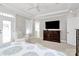 Airy main bedroom featuring a large television, white armchair, and balcony access at 364 Mill Ridge Rd, Rock Hill, SC 29730