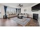 Living room featuring hardwood floors, fireplace, and ample natural light at 4015 Havenport Cir # 119, Tega Cay, SC 29708