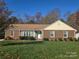 Charming single-story brick home with well-maintained front yard, blue skies and mature landscaping at 433 Pamela St, Gastonia, NC 28054