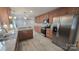 Spacious kitchen boasts stainless steel appliances, granite countertops, and hardwood floors at 433 Pamela St, Gastonia, NC 28054